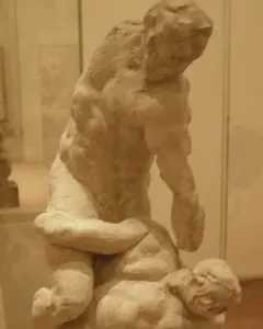 Michelangelo\'s Two Wrestlers, an earthen-toned sculpture of two muscular male figures locked in a wrestling struggle.