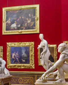 White marble Wrestlers sculpture showing two nude male figures in a wrestling match, one pinning the other to the ground.