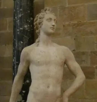 Apollo and Hyacinth marble sculpture showing a standing nude male figure with a seated smaller figure at his feet.