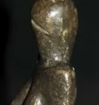 Venus of Dolní Věstonice figurine with a narrow head, prominent breasts, and a tapered body