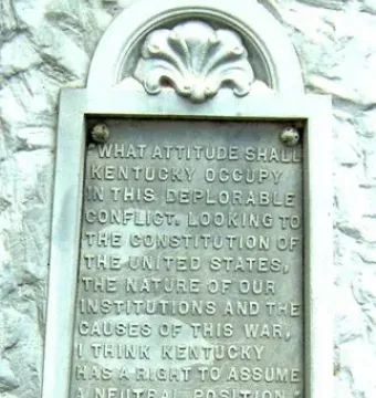 Beriah Magoffin monument plaque with raised lettering and shell-like carvings at the top and bottom