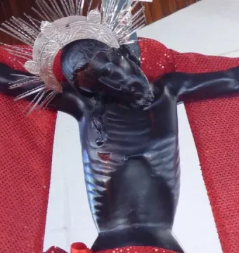 San Juan Patrón crucifix with a silver spiked crown and red drapery