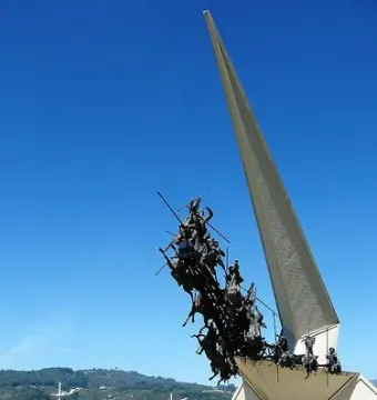 Vargas Swamp Lancers monument with charging horsemen rising from a white base and spire.
