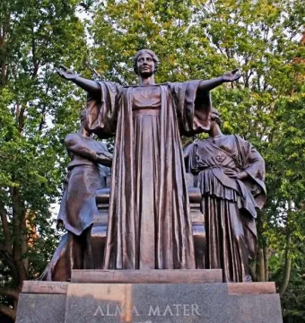 Alma Mater bronze statue with a central robed female figure and two flanking figures on a stone base