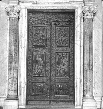 The Filarete Door at St. Peter’s Basilica, shown as an ornate set of double bronze doors with relief panels and fluted columns.