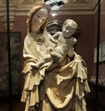 Krumlov Madonna sculpture of a woman cradling a child, with flowing carved drapery