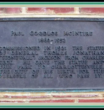Bronze commemorative plaque for Stonewall Jackson mounted on a red brick wall.