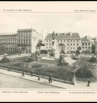Adam Mickiewicz Monument on a tall pedestal in a landscaped urban garden, surrounded by steps, paths, and trees with buildings behind it.