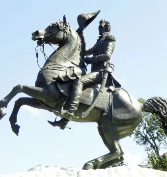 Andrew Jackson statue on a rearing horse against a blue sky
