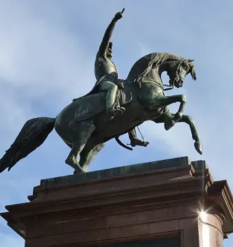 José de San Martín equestrian statue with a rider raising one arm on a rearing horse atop a tiered pedestal.