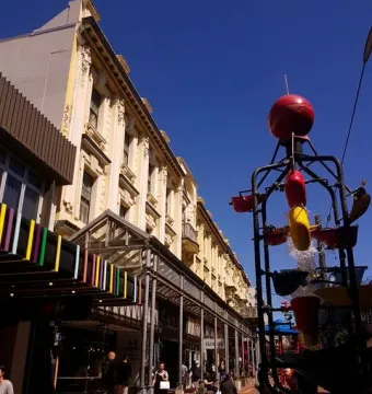 The Bucket Fountain with red and yellow buckets tipping water into a shallow pool in Wellington.