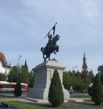El Cid statue showing a rider on a rearing horse holding a spear above a stone pedestal.
