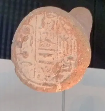 Merimose funerary cone with impressed hieroglyphs on a reddish-brown clay surface.