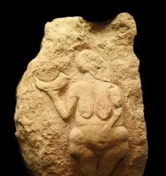 Venus of Laussel stone relief showing a nude female figure holding a curved object.