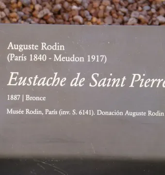 Informational plaque for Eustache de Saint Pierre with artwork details in white text on a grey sign.