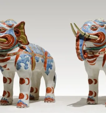 Pair of Kakiemon elephants in white porcelain with blue, red, and gold decoration.