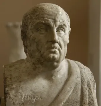 Weathered marble bust of Seneca with draped shoulders and the name carved on the base.