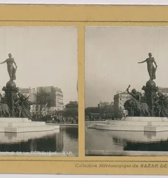 The Triumph of the Republic monument with a female figure atop a globe, surrounded by allegorical figures and lions in a shallow basin.