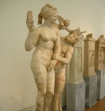 Marble sculpture of Aphrodite with Pan and Eros, showing a nude woman, a horned male figure, and a small winged figure in a struggle.