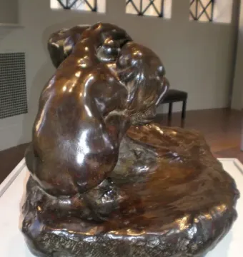 Illusions Received by the Earth bronze sculpture on a white pedestal in a bright room.