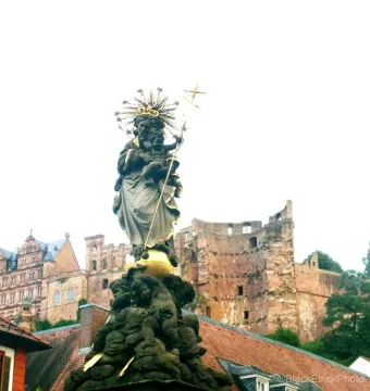 Kornmarkt Madonna, a robed Madonna holding the Christ Child with a starry halo and cross-topped staff, stands above an ornate base.