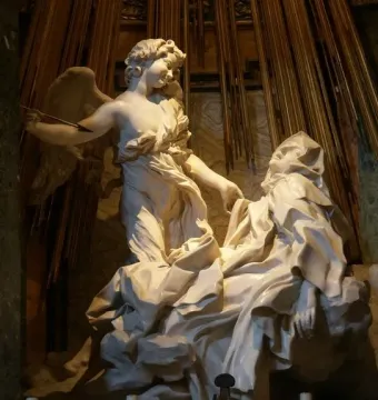 The Ecstasy of Saint Teresa by Bernini, showing a winged angel and a reclining woman beneath golden rays.