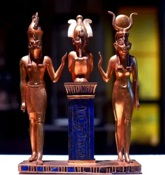 Osorkon II Triad with three golden figures on a base, including a central blue pedestal topped by a small crowned figure.