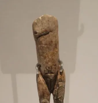 Immodest Venus mammoth ivory figurine with a slender female form on a dark stand