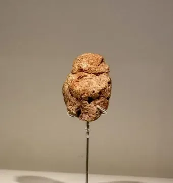 Venus of Berekhat Ram stone figurine on a display stand