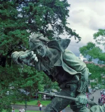 Detail of the National Monument of Costa Rica showing a bronze figure of William Walker lunging forward with a rifle.