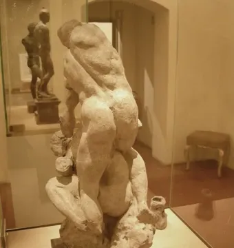 Michelangelo\'s Two Wrestlers sculpture showing two nude male figures grappling in a display case.