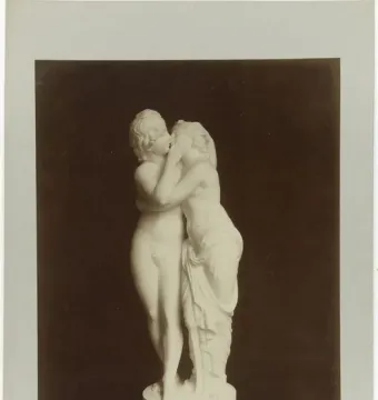 Cupid and Psyche sculpture showing two intertwined figures, one nude and the other partly draped, leaning close together.