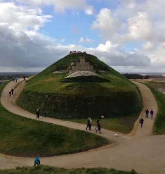 Northumberlandia grassy mound with walking paths and visitors near the summit