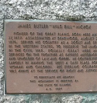 Bronze plaque on the Wild Bill Hickok Memorial with commemorative raised text on granite.
