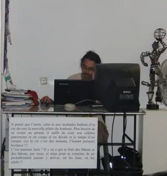 La Nouvelle Liberté sculpture standing on a white pedestal beside a computer monitor and standing fan