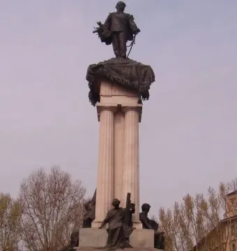 Monument to Vittorio Emanuele II with a bronze statue on a columned pedestal and sculptural figures at the base.