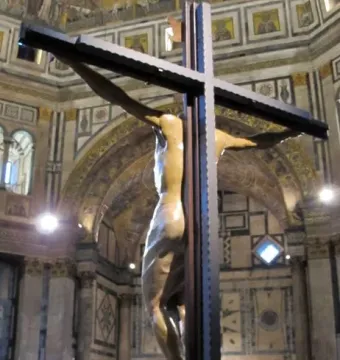 The Santa Croce Crucifix shows a large wooden Christ figure on a dark cross inside a grand church, with visitors gathered below looking up.
