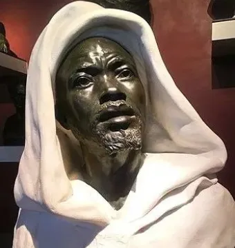 Salem, Negro of Sudan sculpture showing a dark-toned male figure with a short beard, an upward gaze, and a flowing hooded garment.