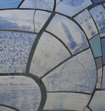 Close-up of the Big Fish sculpture’s blue and white mosaic scales with illustrations and text fragments