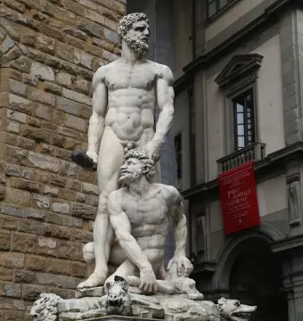 Hercules and Cacus marble sculpture by Baccio Bandinelli, showing a muscular Hercules standing over a subdued bearded figure on a decorated pedestal.