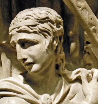 Marble relief of a wavy-haired figure from the Portonaccio Sarcophagus, shown with a downward gaze and draped garment fastened at the shoulder.