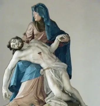 Nenningen Pietà showing a sorrowful woman cradling the body of Christ with visible wounds.