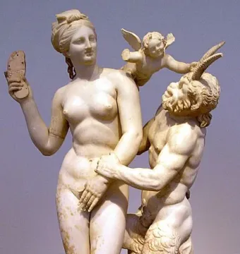 Marble sculpture of Aphrodite, Pan and Eros, with a nude woman holding up a sandal while Pan embraces her and Eros pulls on his horn.
