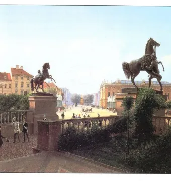 Horse Tamers statues with rearing horses on pedestals in a broad city square.