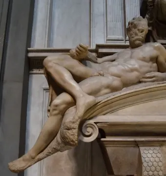 Michelangelo’s Evening, a reclining marble male figure with a bearded face in the Medici Chapel.