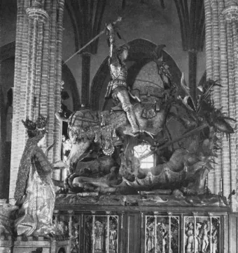 Saint George and the Dragon wooden sculpture showing an armored knight on horseback raising a sword against a dragon, with a crowned figure beside it.