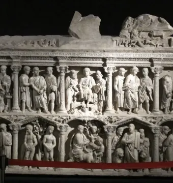The Sarcophagus of Junius Bassus with two carved relief registers showing draped figures in architectural niches.
