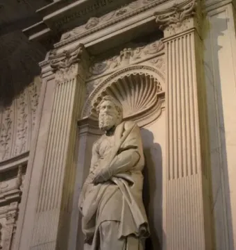 Marble statue of Saint Paul in an ornate niche with a shell-shaped top.