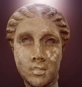 Marble head of Lycosoura Artemis with wavy braided hair swept back
