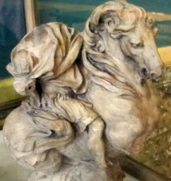 The Vision of Constantine sculpture depicted as a light-colored horse and rider with the rider’s head shrouded in drapery.